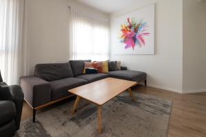 a living room with a couch and a coffee table at Seaside Court Retreat By IsrApart in Tel Aviv