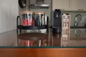 a counter top with a coffee container on top of it at Seaside Court Retreat By IsrApart in Tel Aviv
