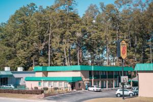 a mcdonalds restaurant with cars parked in a parking lot at Super 8 by Wyndham Columbia/Ft. Jackson SC in Columbia