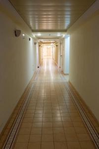 an empty hallway in an office building with ailed floor at Seaside Court Retreat By IsrApart in Tel Aviv