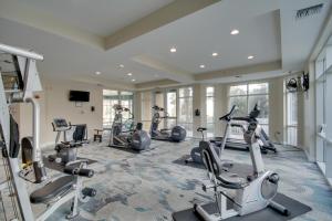 a fitness room with treadmills and elliptical machines at 6th-Floor Gulfport Condo with Views Walk to Beach in Gulfport