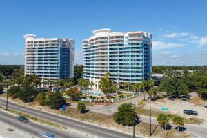 two tall buildings in a city with a highway at 6th-Floor Gulfport Condo with Views Walk to Beach in Gulfport