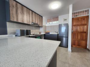 a kitchen with a counter top and a refrigerator at Penzance by the beach in Durban