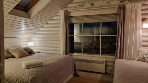 a bedroom with two beds and a window at Guesthouse Delisa in Pärnu