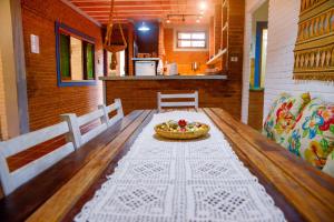 une table de salle à manger avec un bol de fruits dessus dans l'établissement Otima casa c Wi Fi 8 min da praia Barequecaba SP, à São Sebastião