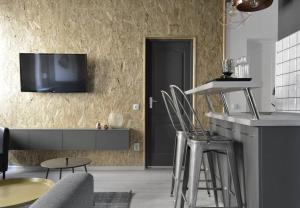a living room with a tv on a wall at 2 Bdr / Cozy Ap Near Old Town in Bucharest