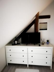 a white dresser with a tv on top of it at ubytování U NIKY in Hodonín