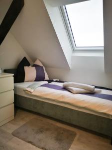 a bed in a room with a window at ubytování U NIKY in Hodonín