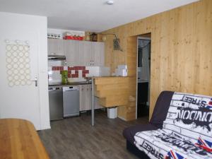a small kitchen with a couch in a room at Appartement Les Adrets-Prapoutel, 2 pièces, 5 personnes - FR-1-557-52 in Les Adrets