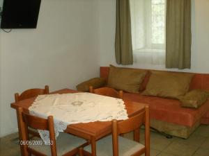 a living room with a table and a couch at Apartments Kleo in Orebić