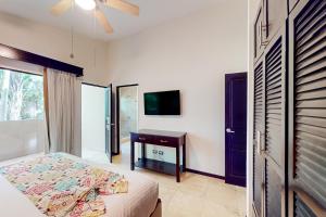 a bedroom with a bed and a desk and a window at The Cove #16 in Ocotal