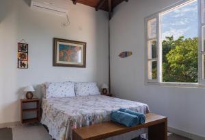 a bedroom with a bed and a window at Casa Boomerang in Marau +84 photos