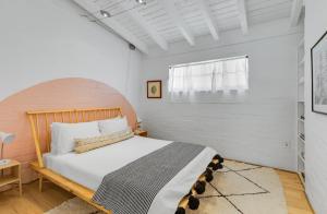 a bedroom with a large bed with a wooden headboard at The Kasbah in Palm Springs +44 photos