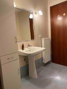 a bathroom with a sink and a mirror at Riga's modern attic in Drama