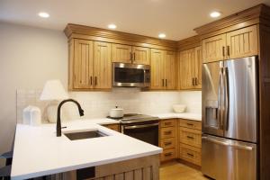 a kitchen with wooden cabinets and a stainless steel refrigerator at Red Pine Wonder in Park City