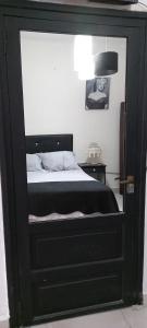 a bedroom with a black cabinet with a bed at Anita in Villa Mercedes