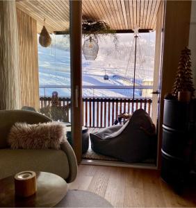 a living room with a sliding glass door to a balcony at the NEST flims in Flims