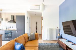 Il comprend un salon avec un canapé et une cuisine. dans l'établissement Appartamento Milano Infinite Dreams 1 min MM1, à Milan
