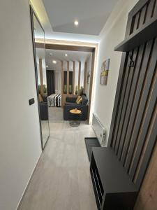a hallway leading to a living room with a mirror at Dux Apartmani - Milmari, Kopaonik in Cajetina +27 photos