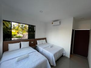 1 dormitorio con 2 camas y ventana en Hotel Paseo del Sol, en La Paz