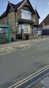 a house on the side of a street with a bus stop at Fair Oak Self-Catering Accomodation in Sandown