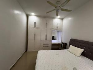 a bedroom with a bed and a ceiling fan at Prime Villa in Kuala Lumpur