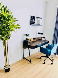 a desk and a chair in a room with a plant at Views on the six in Midrand