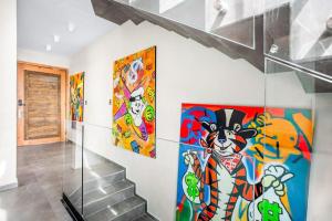 a staircase with colorful paintings on the wall at Kite 201 in Tulum