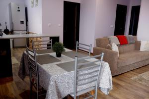a living room with a table and a couch at Village Center Two Bedroom Apartment in Porto Moniz
