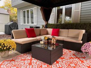 a patio with a couch and a coffee table at Cozy 3 bdr Retreat in a Prime location in Streamwood