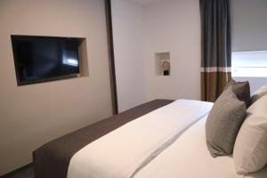 Postel nebo postele na pokoji v ubytování HUNICO HOTEL