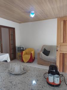 een woonkamer met een bank en een tafel bij Casa Perto Praia do Forte in Cabo Frio
