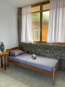 1 dormitorio con 2 camas y ventana en Malevo Suites - Apartments, en Ayampe