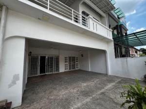 an empty garage in a white building with a balcony at Prime Villa in Kuala Lumpur