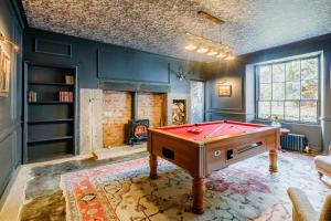 a room with a pool table and a fireplace at Manar House Ground Floor Luxury Apartment in Inverurie
