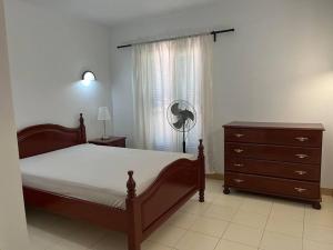 a bedroom with a bed and a dresser and a window at Holiday Home - Santa Maria in Prainha