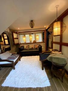 a living room with a couch and a white rug at Chalé Pipa Atlântico in Pipa +50 photos