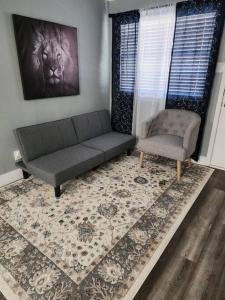 a living room with a couch and a chair at Blue Shark *G13* @ Midtown Central 1BR King Apartment in Houston