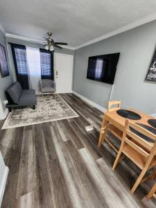 a living room with a table and a chair at Blue Shark *G13* @ Midtown Central 1BR King Apartment in Houston