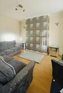 a living room with a couch and a table at The Smart Stay - sleeps 5 Wigan central location in Wigan