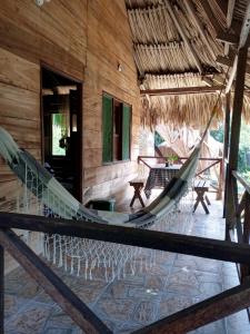 a hammock in the middle of a house at ECOCABAÑAS DIOSA JAGUAR tayrona in Santa Marta