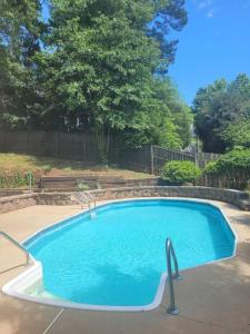 a large swimming pool in a yard at Escape to Serenity Luxurious 4Bedroom 3Bath Oasis with Private Pool Near Fort Jackson in Columbia