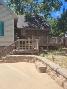 a house with a porch and a wooden deck at Escape to Serenity Luxurious 4Bedroom 3Bath Oasis with Private Pool Near Fort Jackson in Columbia