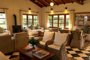 a living room with couches and a table at Estancia Iberá in Colonia Carlos Pellegrini