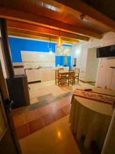 a room with a kitchen and a dining room with a table at La Casita Encendida in Villamayor de Campos
