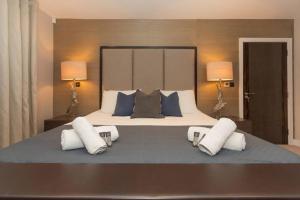 ein Schlafzimmer mit einem großen Bett mit drei Kissen in der Unterkunft Luxury Penthouse Apartment With Hot Tub in Bath
