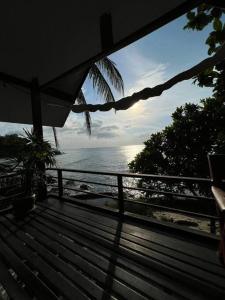 a view of the ocean from a wooden deck at Sea Lulaby in Koh Phangan