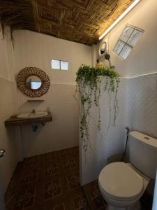 a bathroom with a toilet and a sink and a mirror at Sea Lulaby in Koh Phangan