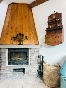 a living room with a fireplace with a wooden ceiling at Casa Francesca in Ponte di Legno