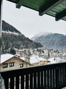 a view of a town in the snow from a balcony at Casa Francesca in Ponte di Legno